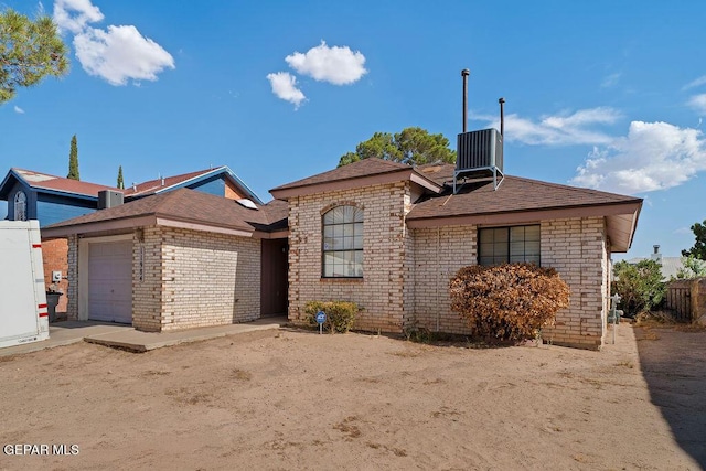11984 Manuel Acosta Dr, El Paso, TX 79936 - view of front facade with an attached garage, brick siding, and a shingled roof