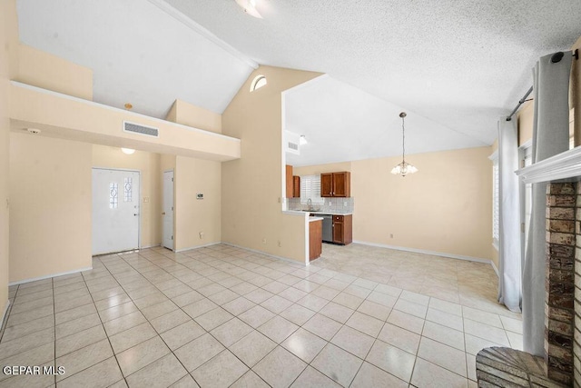 11984 Manuel Acosta Dr, El Paso, TX 79936 - unfurnished living room featuring light tile patterned flooring, high vaulted ceiling, and a chandelier