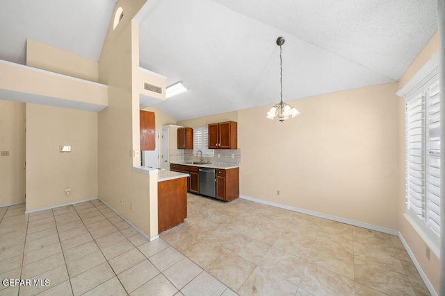 11984 Manuel Acosta Dr, El Paso, TX 79936 - kitchen with stainless steel dishwasher, lofted ceiling, a chandelier, light countertops, and plenty of natural light
