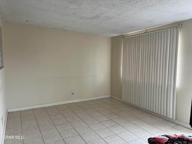 327 Jesuit Dr, El Paso, TX 79907 - unfurnished room with a textured ceiling and light tile patterned floors