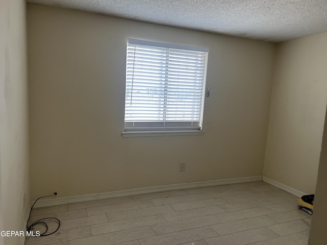 327 Jesuit Dr, El Paso, TX 79907 - empty room featuring a textured ceiling and baseboards