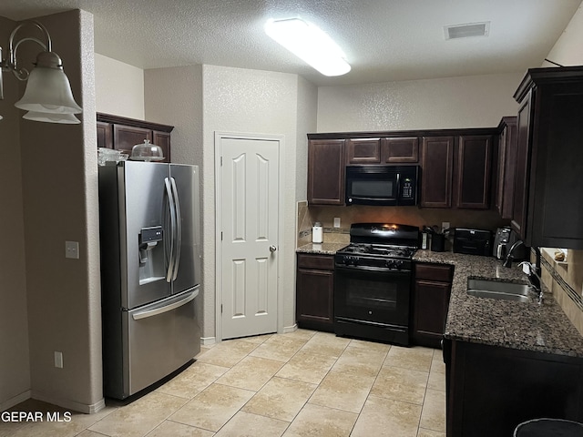 14428 Johnny Mata Dr, El Paso, TX 79938 - kitchen with black appliances, dark stone counters, a textured wall, light tile patterned flooring, and dark brown cabinets