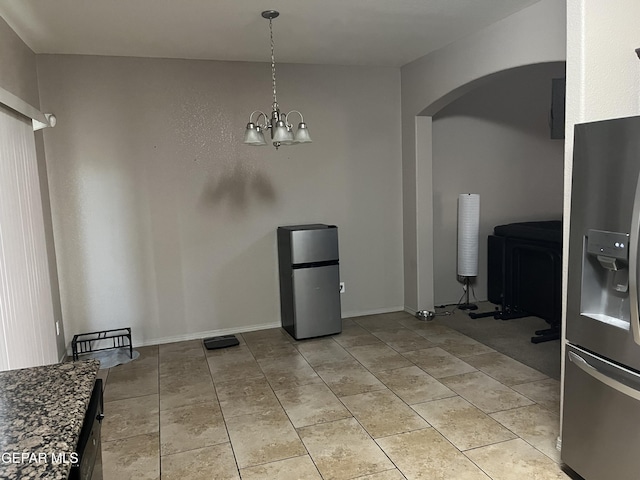 14428 Johnny Mata Dr, El Paso, TX 79938 - unfurnished dining area with arched walkways and a chandelier