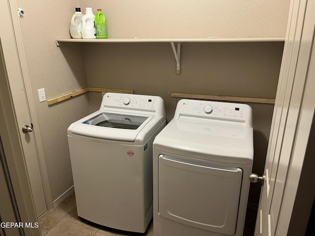 14428 Johnny Mata Dr, El Paso, TX 79938 - laundry room featuring washer and clothes dryer and light tile patterned floors