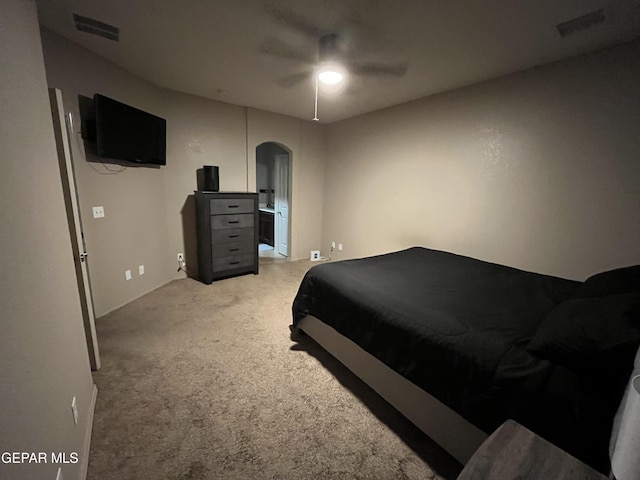14428 Johnny Mata Dr, El Paso, TX 79938 - bedroom featuring arched walkways, light carpet, and a ceiling fan