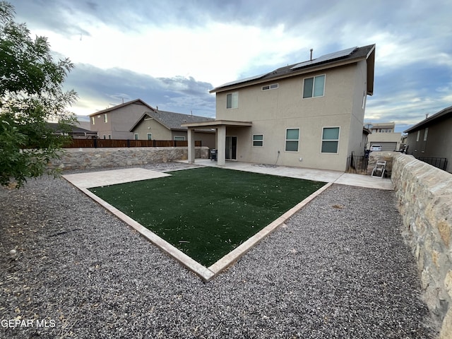 14428 Johnny Mata Dr, El Paso, TX 79938 - back of property featuring stucco siding, a patio area, solar panels, and a fenced backyard