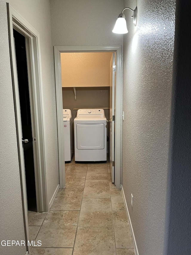 14428 Johnny Mata Dr, El Paso, TX 79938 - washroom with washing machine and clothes dryer and a textured wall