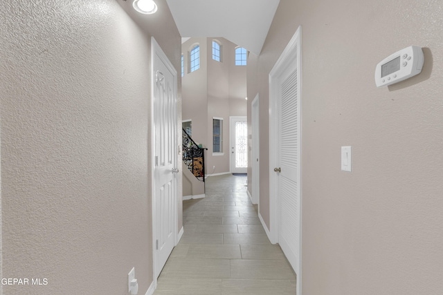 3165 Destiny Point Dr, El Paso, TX 79938 - hallway with a textured wall, light tile patterned floors, and lofted ceiling