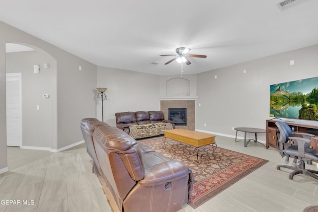 3165 Destiny Point Dr, El Paso, TX 79938 - living area featuring a ceiling fan, arched walkways, a fireplace, and an office area