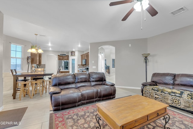3165 Destiny Point Dr, El Paso, TX 79938 - living area with arched walkways, ceiling fan, and a chandelier