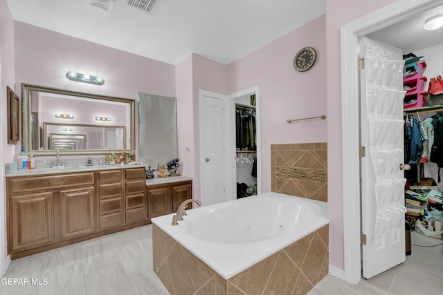 3165 Destiny Point Dr, El Paso, TX 79938 - full bath with vanity, a tub with jets, and a walk in closet