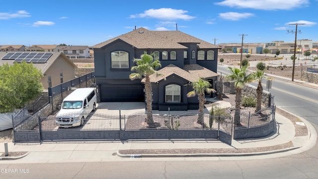 3165 Destiny Point Dr, El Paso, TX 79938 - view of front of property featuring an attached garage, a fenced front yard, driveway, stucco siding, and a shingled roof