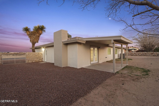 15081 Darrington Rd, Horizon City, TX 79928 - rear view of house with stucco siding, a chimney, and a patio area