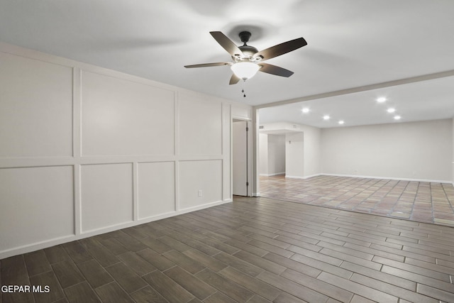 15081 Darrington Rd, Horizon City, TX 79928 - unfurnished room featuring a decorative wall, ceiling fan, recessed lighting, and dark wood-style flooring
