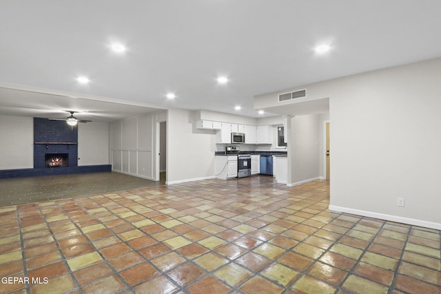 15081 Darrington Rd, Horizon City, TX 79928 - unfurnished living room with recessed lighting, a brick fireplace, and tile patterned floors
