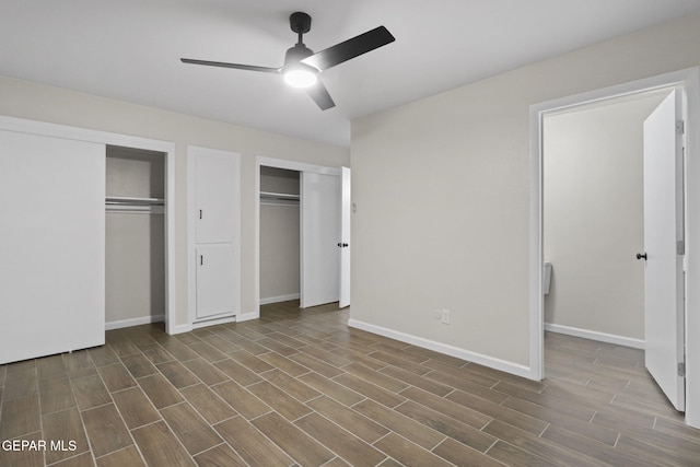 15081 Darrington Rd, Horizon City, TX 79928 - unfurnished bedroom featuring dark wood-style floors, two closets, and ceiling fan