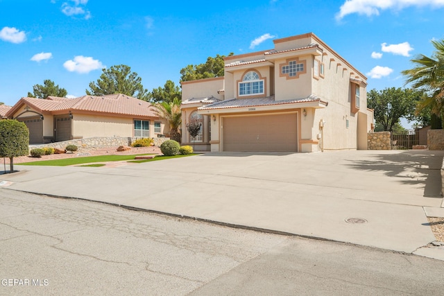 18986 Armington Dr, Horizon City, TX 79928 - mediterranean / spanish-style home featuring stucco siding, an attached garage, a tiled roof, and concrete driveway