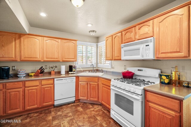 18986 Armington Dr, Horizon City, TX 79928 - kitchen with white appliances, recessed lighting, stone finish floors, light countertops, and light brown cabinets
