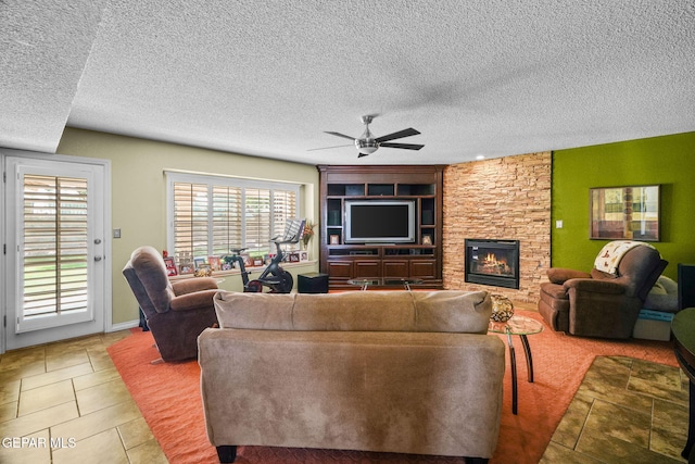18986 Armington Dr, Horizon City, TX 79928 - tiled living room with ceiling fan, plenty of natural light, a textured ceiling, and a fireplace