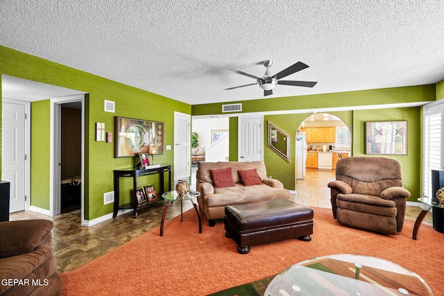 18986 Armington Dr, Horizon City, TX 79928 - living area featuring a ceiling fan, a textured ceiling, and arched walkways