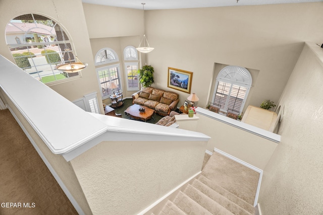 18986 Armington Dr, Horizon City, TX 79928 - stairway featuring a high ceiling, carpet floors, and healthy amount of natural light