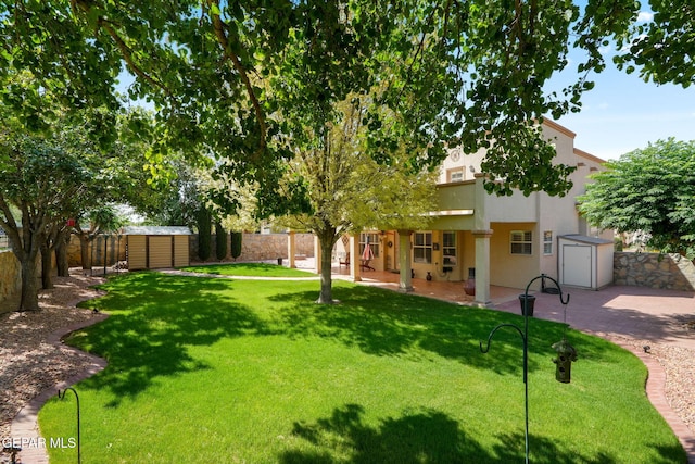 18986 Armington Dr, Horizon City, TX 79928 - fenced backyard featuring a storage unit and a patio area