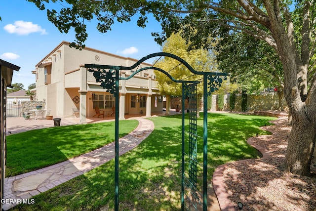 18986 Armington Dr, Horizon City, TX 79928 - rear view of house with stucco siding and a patio area