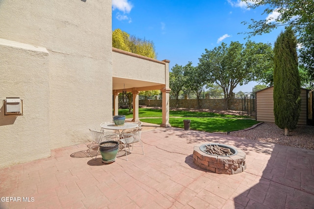 18986 Armington Dr, Horizon City, TX 79928 - view of patio / terrace featuring an outdoor fire pit and a storage shed