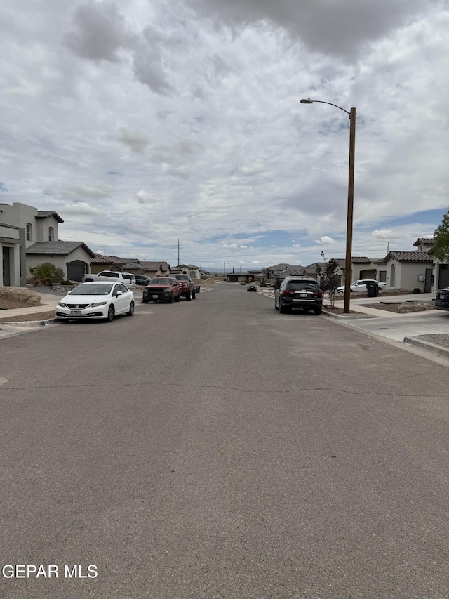 229 Epsom Dr, El Paso, TX 79928 - view of asphalt street with sidewalks, street lights, curbs, and a residential view