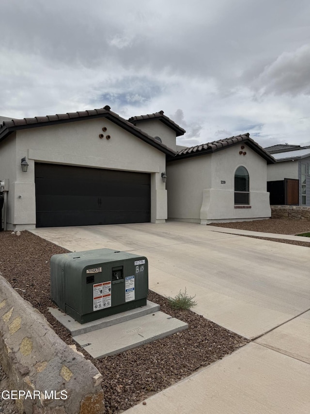 229 Epsom Dr, El Paso, TX 79928 - mediterranean / spanish-style house with a garage, stucco siding, concrete driveway, and a tile roof