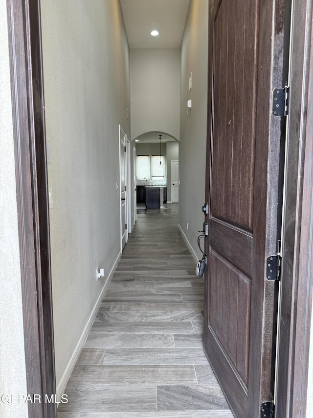 229 Epsom Dr, El Paso, TX 79928 - hall with arched walkways and light wood-style floors