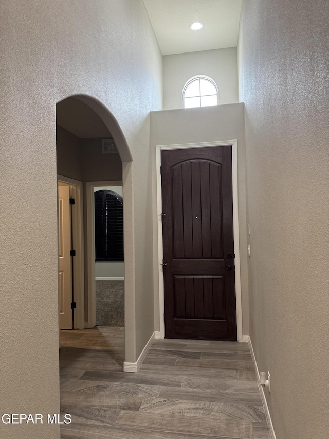 229 Epsom Dr, El Paso, TX 79928 - foyer entrance with wood finished floors, a textured wall, and arched walkways