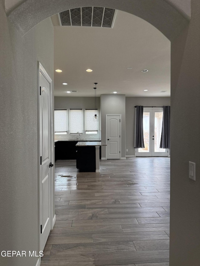 229 Epsom Dr, El Paso, TX 79928 - hallway with arched walkways, recessed lighting, french doors, and wood finished floors