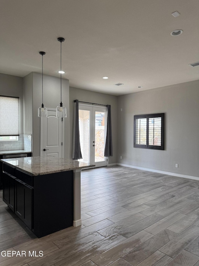 229 Epsom Dr, El Paso, TX 79928 - kitchen featuring a kitchen island, light wood-style flooring, light stone countertops, and recessed lighting