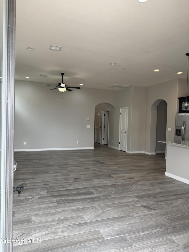 229 Epsom Dr, El Paso, TX 79928 - unfurnished living room with arched walkways, a ceiling fan, recessed lighting, and wood finished floors