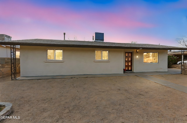 125 N Nevarez Rd, Socorro, TX 79927 - back of property at dusk with stucco siding and a patio