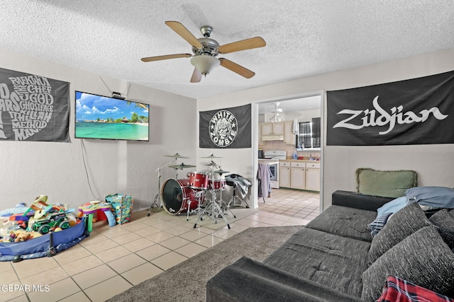 4330 Frankfort Ave, El Paso, TX 79903 - playroom with light tile patterned flooring, a ceiling fan, and a textured ceiling