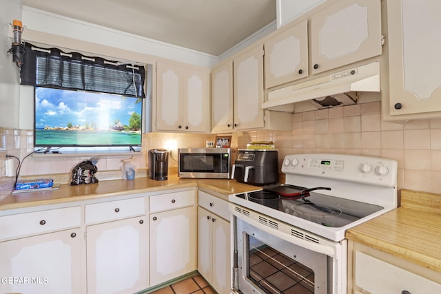 4330 Frankfort Ave, El Paso, TX 79903 - kitchen with white electric stove, under cabinet range hood, stainless steel microwave, and light countertops