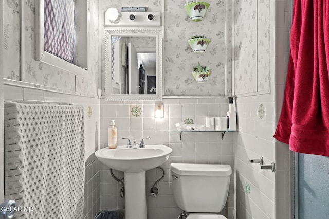 4330 Frankfort Ave, El Paso, TX 79903 - half bathroom featuring tile walls, wallpapered walls, and wainscoting
