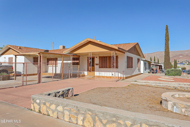 4330 Frankfort Ave, El Paso, TX 79903 - view of front of home featuring a porch, stucco siding, roof with shingles, and a mountain view