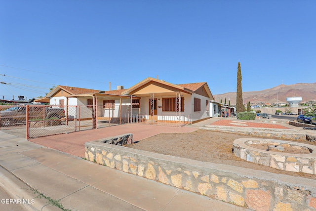 4330 Frankfort Ave, El Paso, TX 79903 - manufactured / mobile home with covered porch, stucco siding, concrete driveway, a mountain view, and a carport