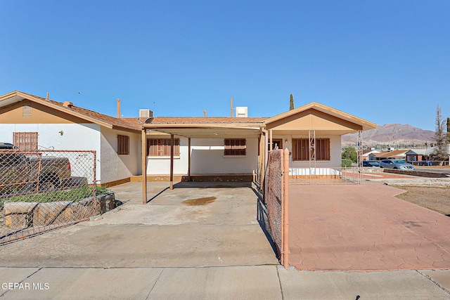 4330 Frankfort Ave, El Paso, TX 79903 - view of front facade with a mountain view, a carport, stucco siding, driveway, and covered porch
