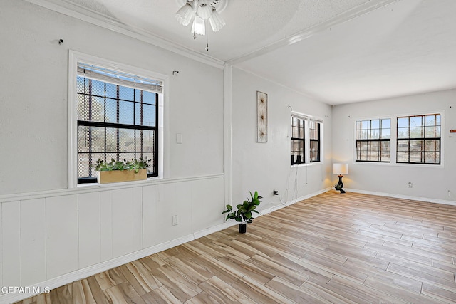 4330 Frankfort Ave, El Paso, TX 79903 - empty room with wood finished floors, ceiling fan, a textured ceiling, a wainscoted wall, and crown molding