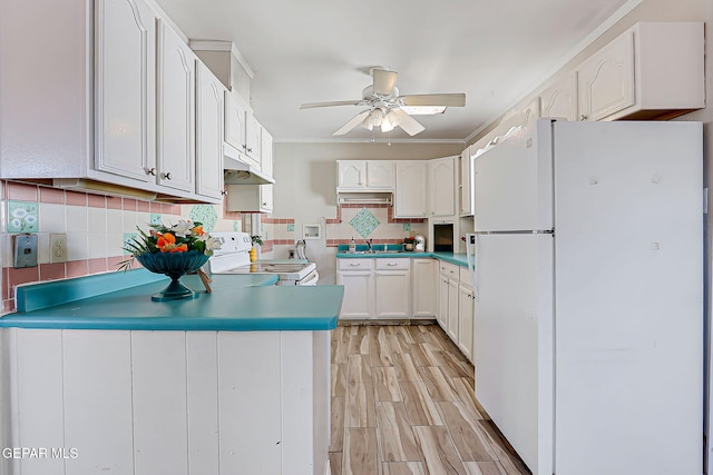 4330 Frankfort Ave, El Paso, TX 79903 - kitchen with white appliances, under cabinet range hood, ceiling fan, a peninsula, and white cabinetry