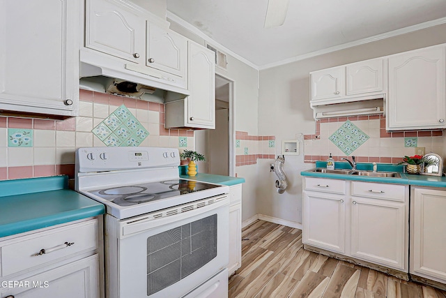 4330 Frankfort Ave, El Paso, TX 79903 - kitchen featuring white electric range oven, under cabinet range hood, backsplash, white cabinets, and crown molding