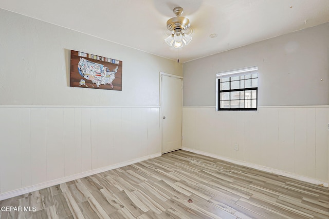 4330 Frankfort Ave, El Paso, TX 79903 - unfurnished room featuring wood finished floors, ceiling fan, and a wainscoted wall