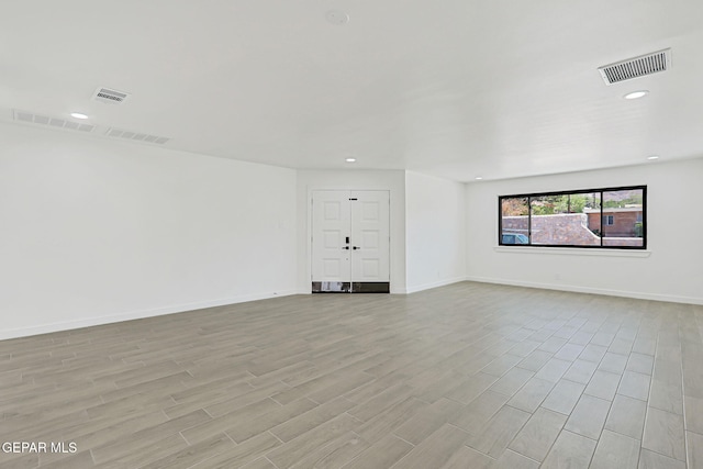5841 Burning Tree Dr, El Paso, TX 79912 - empty room featuring light wood-type flooring and recessed lighting