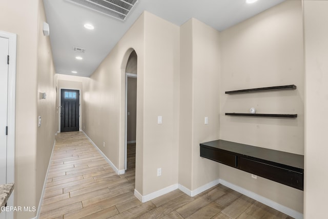 13597 Gatton St, El Paso, TX 79928 - hall featuring light wood finished floors, arched walkways, and recessed lighting