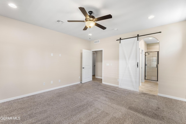 13597 Gatton St, El Paso, TX 79928 - unfurnished bedroom featuring light colored carpet, a barn door, recessed lighting, and a ceiling fan
