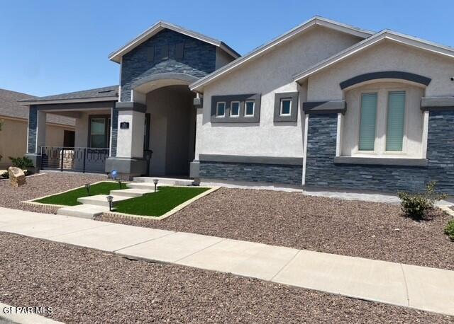 2813 Mike Price Dr, El Paso, TX 79938 - view of front of home featuring stone siding, stucco siding, and covered porch